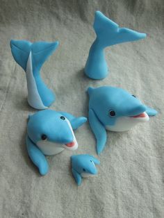 there are three blue dolphin figurines on the bed