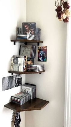 the corner shelf is filled with books and cds