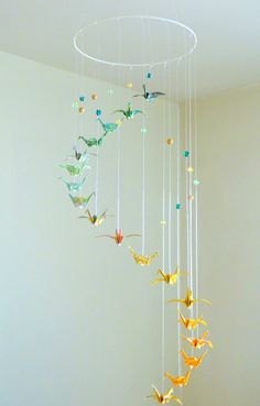 a wind chime hanging from the ceiling in a room with white walls and flooring