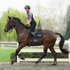 a woman riding on the back of a brown horse