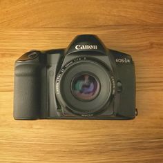 a camera sitting on top of a wooden table