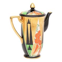 a ceramic teapot with an artistic design on it