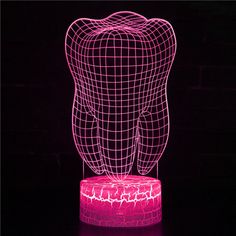 a 3d image of a tooth on top of a pink base with an electric light