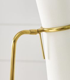 a close up of a gold metal object on a white cloth