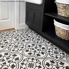 a bathroom with black and white tiles on the floor