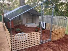 a fenced in backyard area with an enclosure