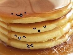 stack of pancakes with faces drawn on them