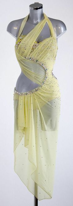 a woman's yellow dress on display in front of a white background