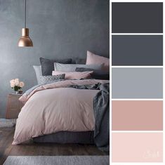 a bedroom with grey walls and pink bedding