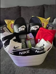 a basket filled with nike shoes and other items