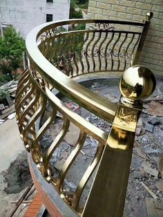 a gold railing on top of a brick building