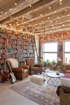 a living room filled with lots of furniture and bookshelves next to a window