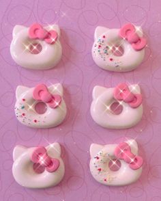 hello kitty doughnuts with pink bows and sprinkles on purple background