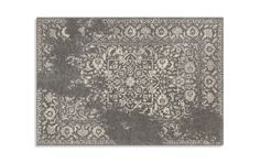 a gray rug with an intricate design on the front and back side, in grey tones