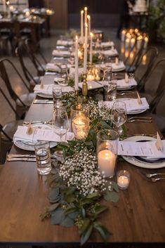 a long table is set with candles and place settings