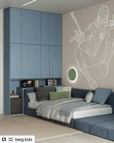 a room with a bed, couch and wall decal in the shape of a spider man