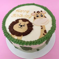 a birthday cake with a lion and giraffe on it