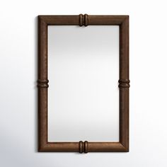 an old wooden frame hanging on the wall with a mirror in it's center