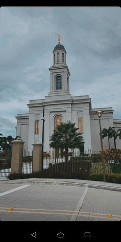 a large white building with a cross on top