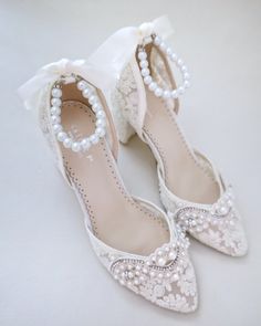 Crochet Lace Wedding Shoes Collection. Classic and refined almond toe crochet lace with added pearls applique. Choose from regular ankle straps or pearl ankle straps and tie silky ribbon bow at the back for a secure fitting. The luminous pearls makes this a classy and elegant bridal shoes.DETAILS:HEELS: 2.75 inchesCOLORS AVAILABLE: Ivory, White and Light BlueUPPER: Synthetic upper and liningMATERIALS: Manmade outsoleORIGIN: ImportedSTYLE NAME: ABBY Pearl Straps, Shoes For Brides, Lace Wedding Shoes, Shoes Details, Wedding Shoes Lace, Ankle Wrap, Bride Shoes, Shoes Collection, Ivory Lace