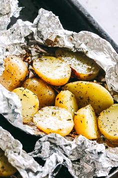 potatoes in tin foil with seasoning on top