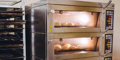 bread baking in an industrial oven with the light on