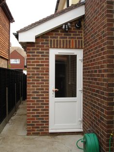 a small brick house with a white door