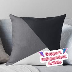 a black and white pillow with the words support independent artists on it