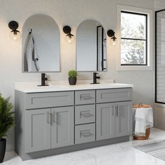 a bathroom with double sinks and mirrors on the wall