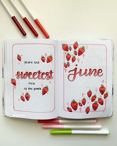 an open notebook with strawberries on it and the words sweetest june written in cursive writing