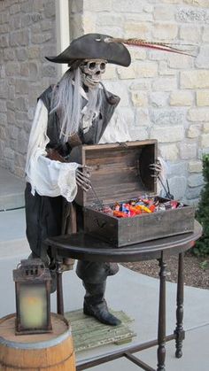 a statue of a pirate with a chest of candy