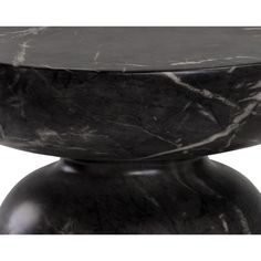 a black and white marbled table top on a round pedestal with an oval base