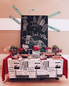 a table topped with lots of food next to a chalkboard