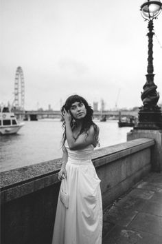 Bride standing by the River Thames in London with London Eye in the background. Home Maternity Photography, Motherhood Photography