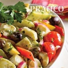 a white bowl filled with vegetables on top of a table