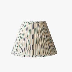 a white lamp shade with blue and green stripes