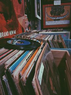 a record player sitting on top of a pile of records