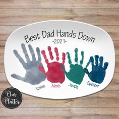 the best dad hands down plate has five different handprints and is on it