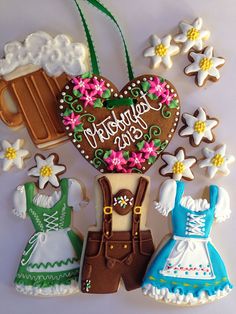 three decorated cookies with beer and flowers on the top one has a heart shaped cookie