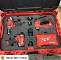 a red tool box filled with tools on top of a table