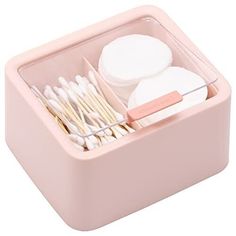 a pink container filled with toothbrushes and other items