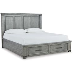 a bed with two drawers underneath it and white sheets on the bottom half of the bed