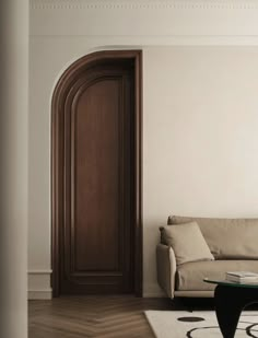 a living room with a white couch and wooden door