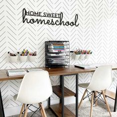 a desk with two chairs next to it and a sign that says home sweet homeschool