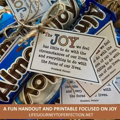 a pile of chocolate candies with the words joy written on them and tied in twine