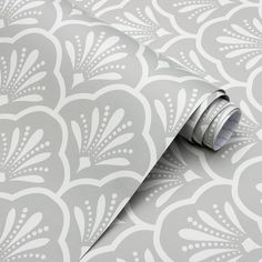 a grey and white wallpaper with an intricate design on it's surface,