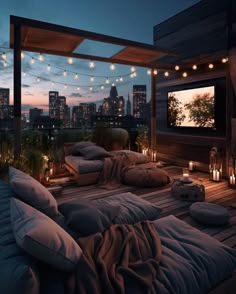 a bed with pillows and blankets on it in front of a cityscape at night