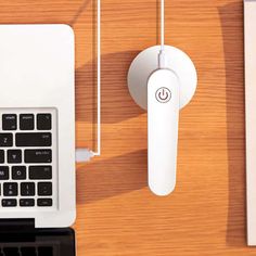 a laptop computer sitting on top of a wooden desk next to a mouse and keyboard