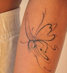 a close up of a person's arm with a butterfly tattoo on the side