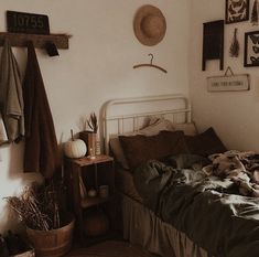 a bed sitting in a bedroom next to a wooden shelf filled with blankets and other items